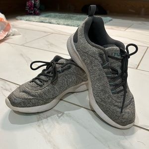 Woman’s gray tennis shoes